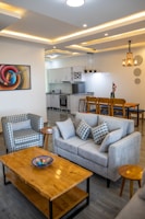 A modern living room featuring a sleek sofa and a stylish armchair.