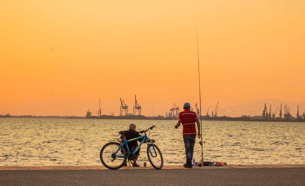 A man and a boy fishing photo – Free Orange Image on Unsplash