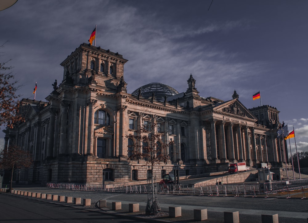 a large building with flags in front of it