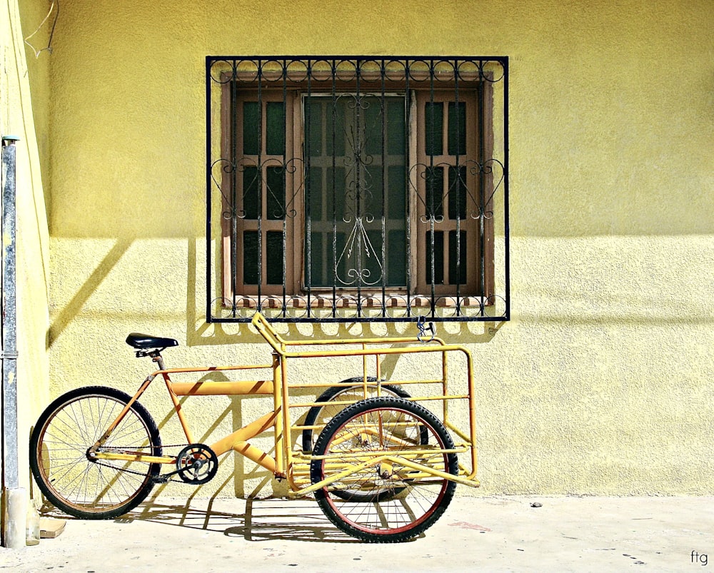 a bicycle parked in front of a window