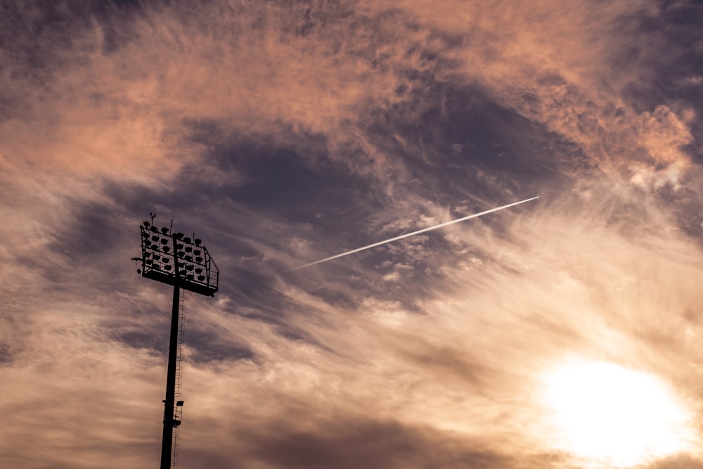 a street light with a cloudy sky