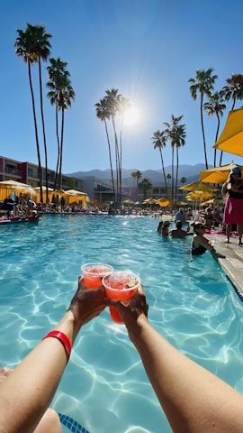 Happy family enjoying a poolside with tropical drinks and smiles