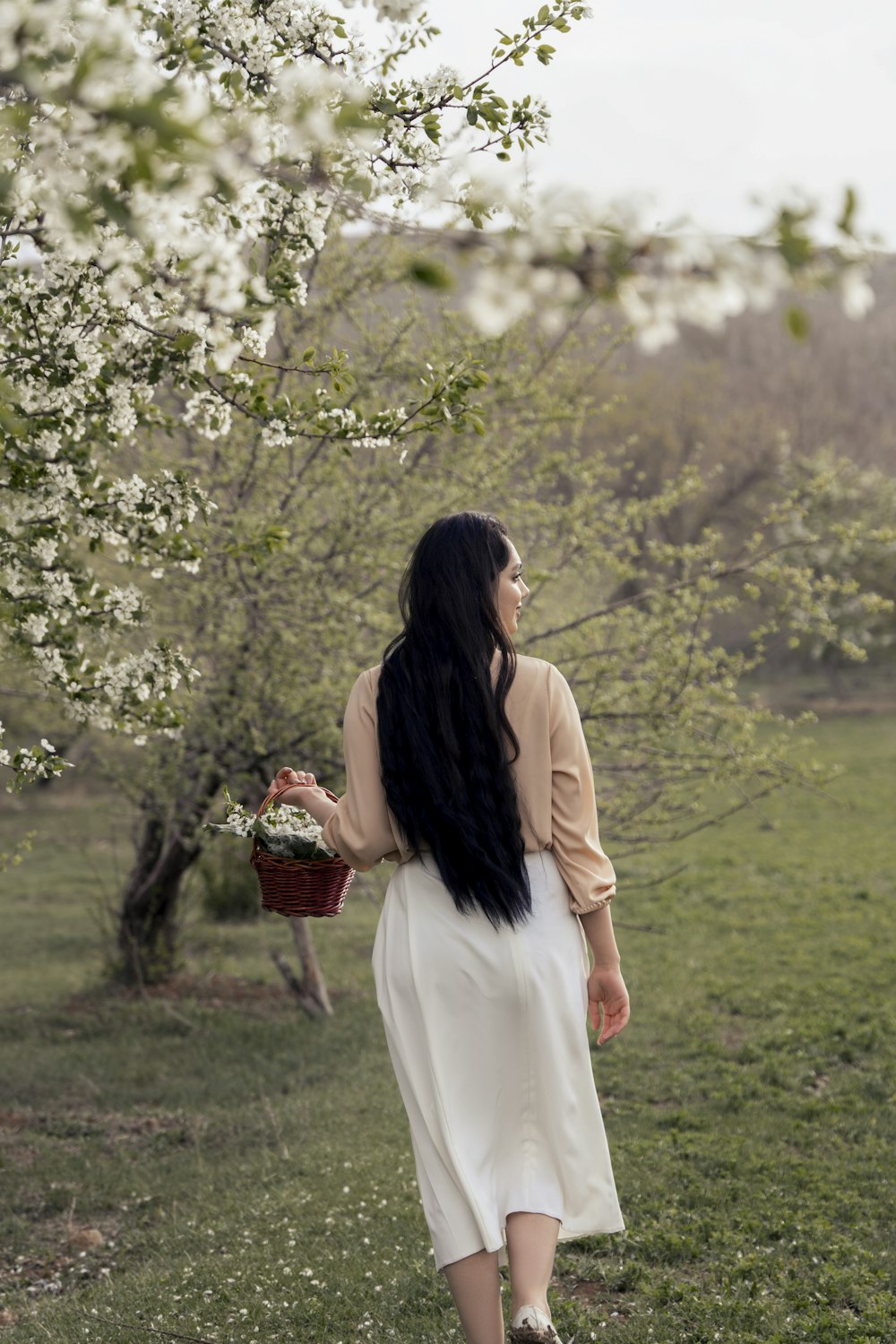 a person holding a basket of flowers