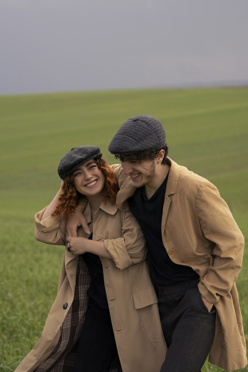 a man and woman hugging in a field