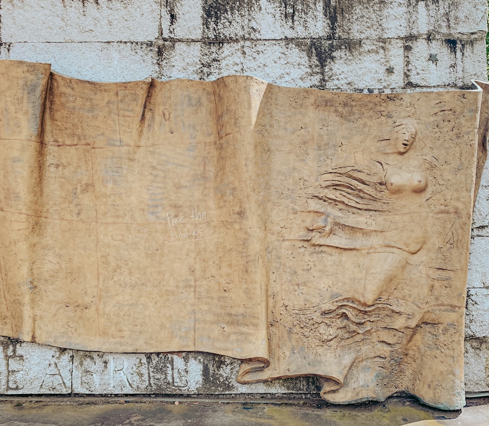 a stone carving of a man and woman