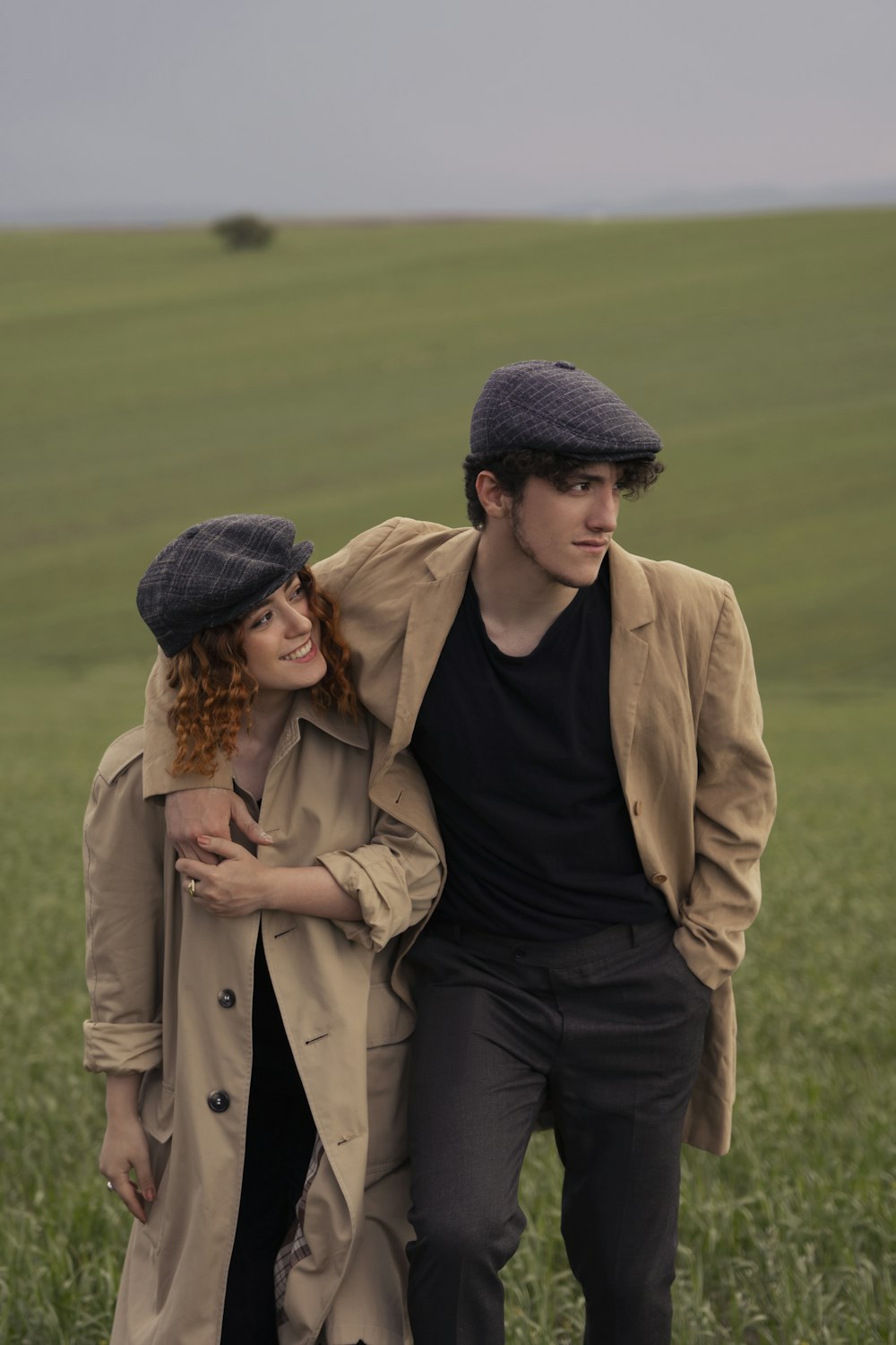 a man and woman standing in a field