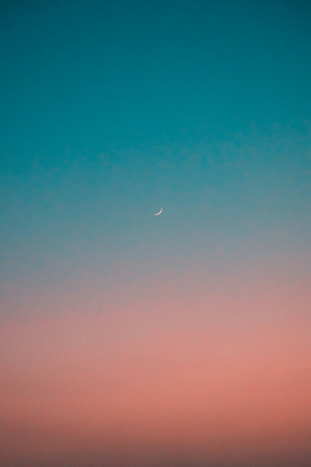 a blue sky with a crescent moon