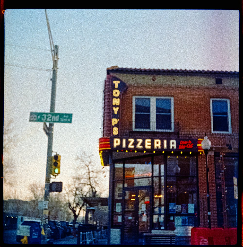 a street sign in front of a restaurant