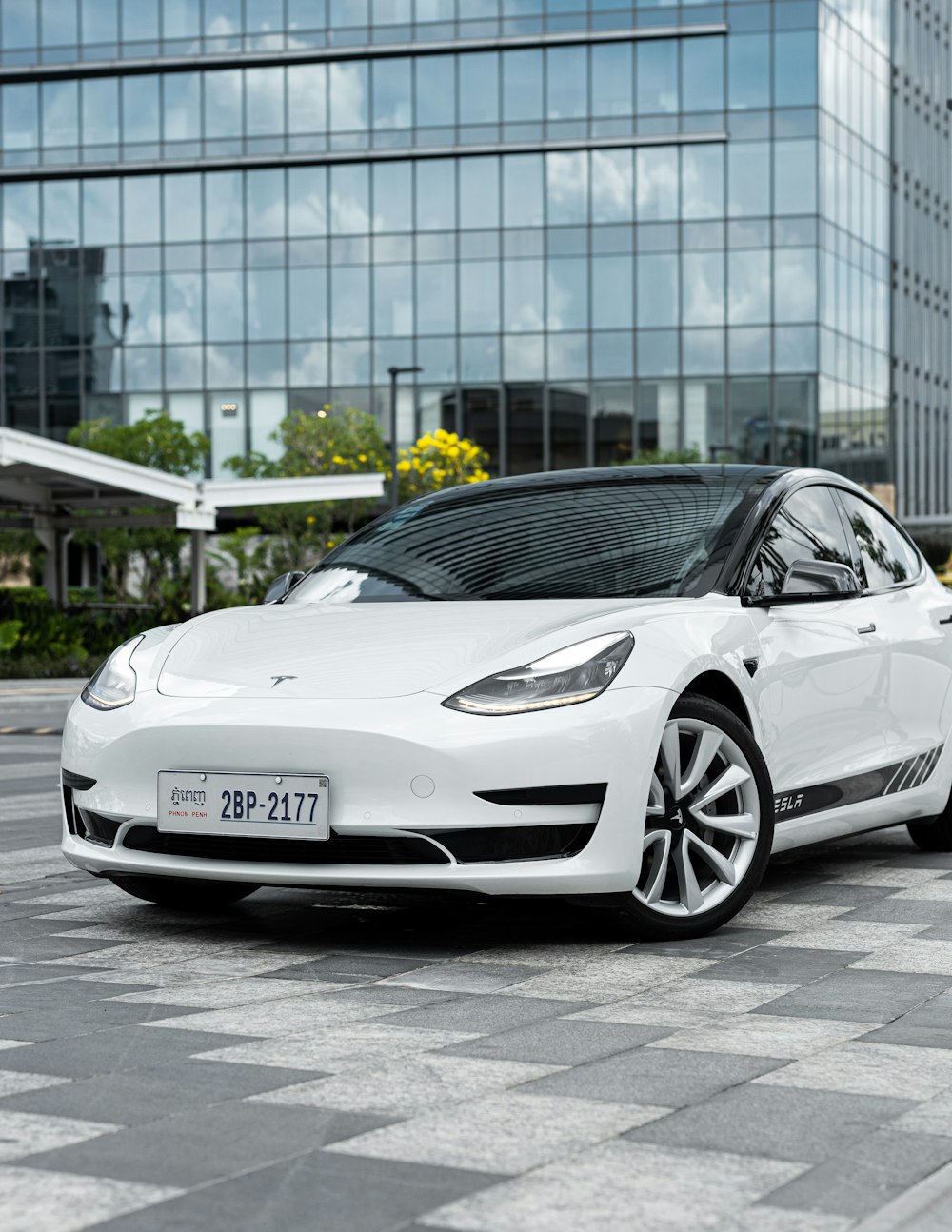 a white car parked in front of a building