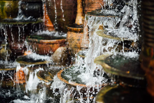 A realistic BIM rendering showing a multi-tiered waterfall with piping and structural details.