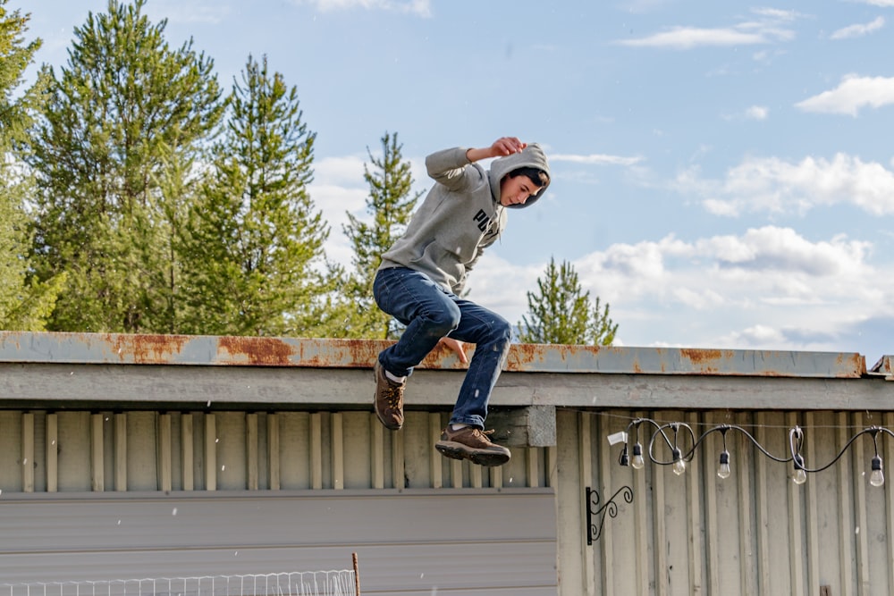 a man jumping on a roof