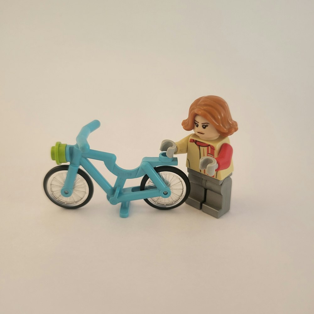 a toy figurine on a bike