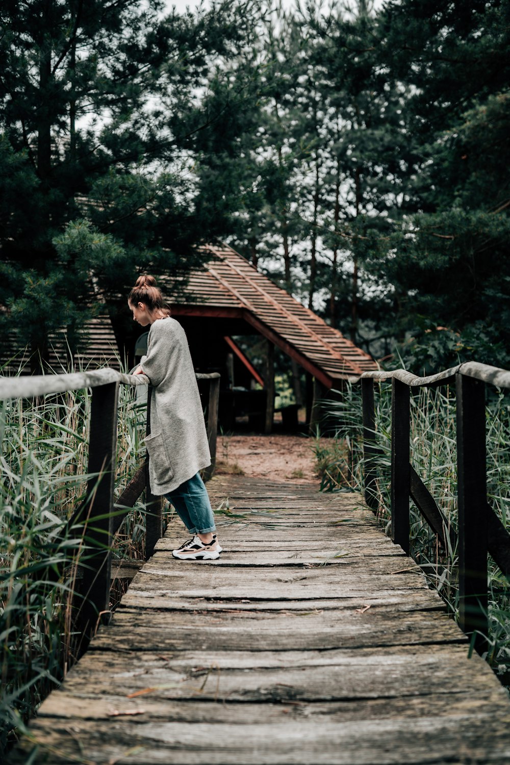 a man walking on a wooden bridge