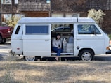 Veterinary technician positioning a calm dog for a mobile MRI scan inside a sleek van