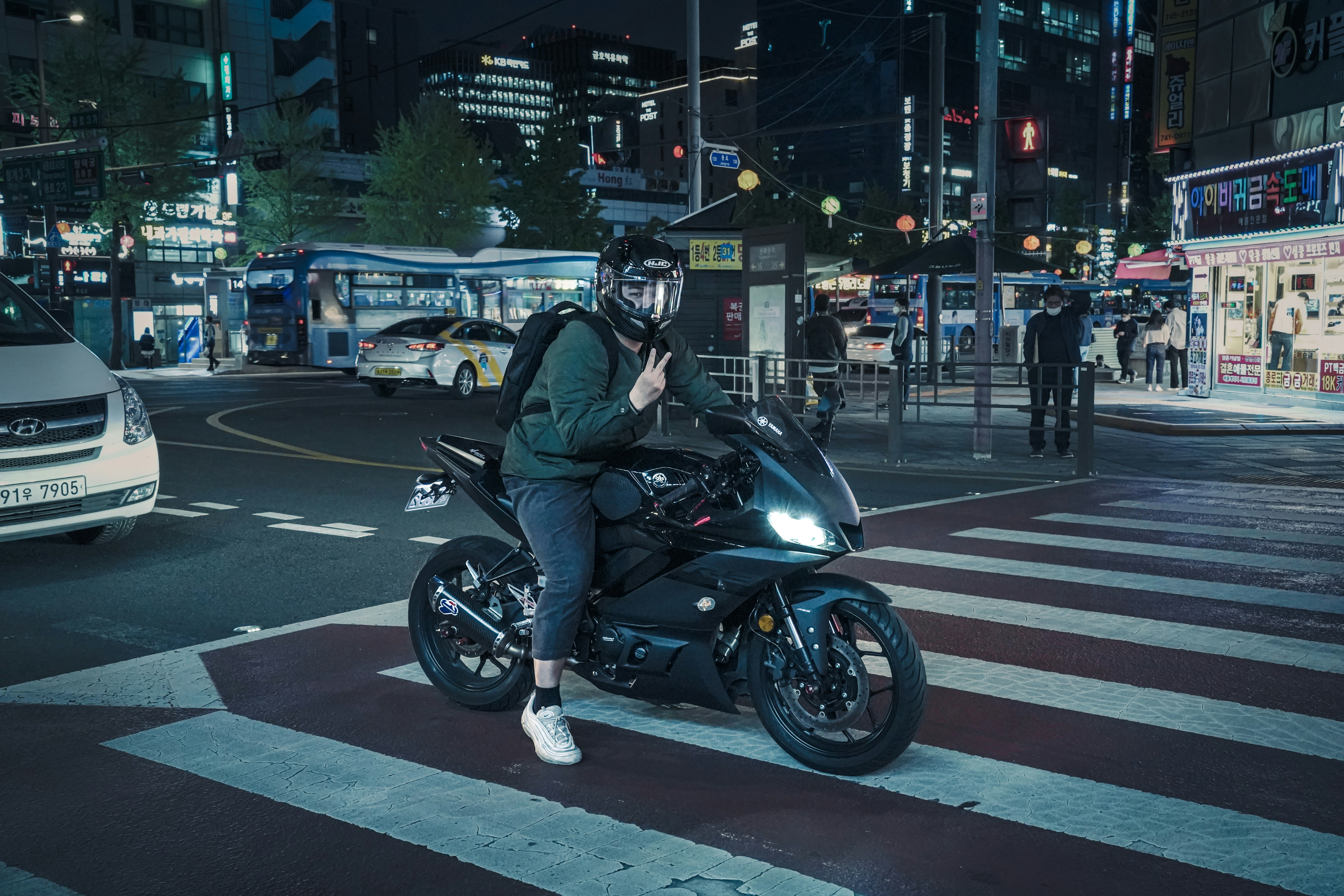 a person on a motorcycle in the middle of a busy street