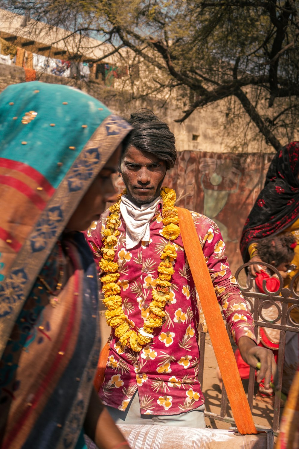 a person wearing a colorful headdress and holding an umbrella