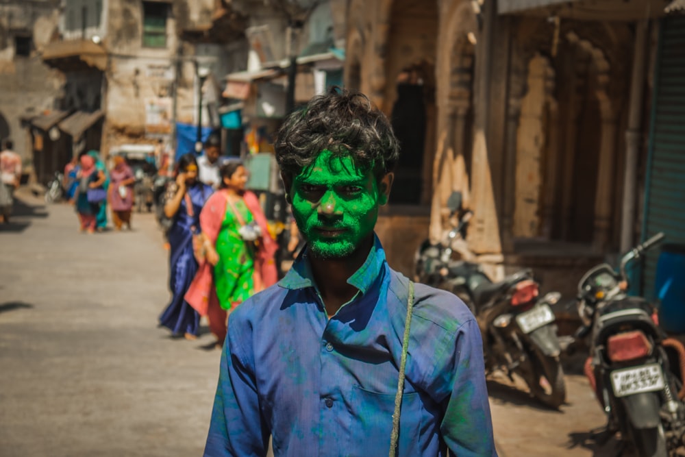 a person with green paint on the face