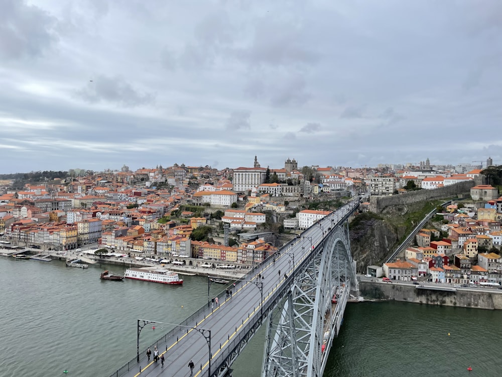 a bridge over a river with a city in the background