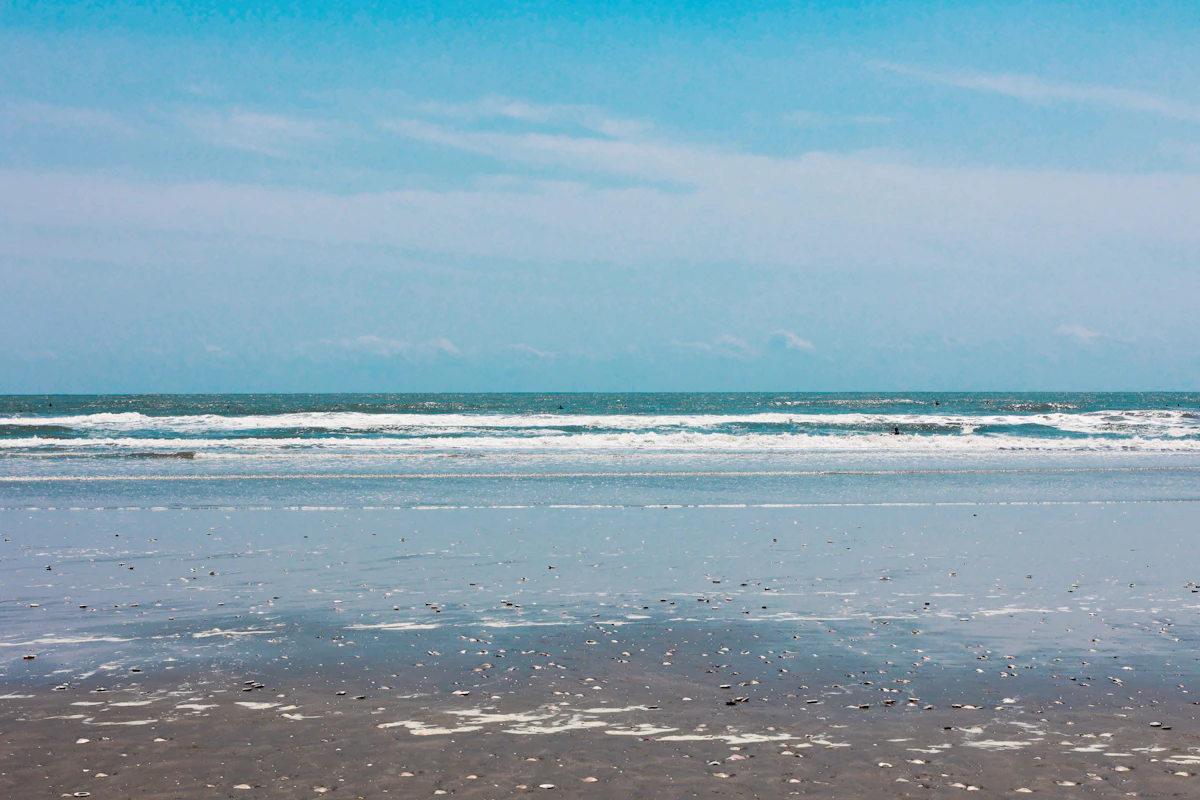 A wide sandy beach with gentle waves in Japan