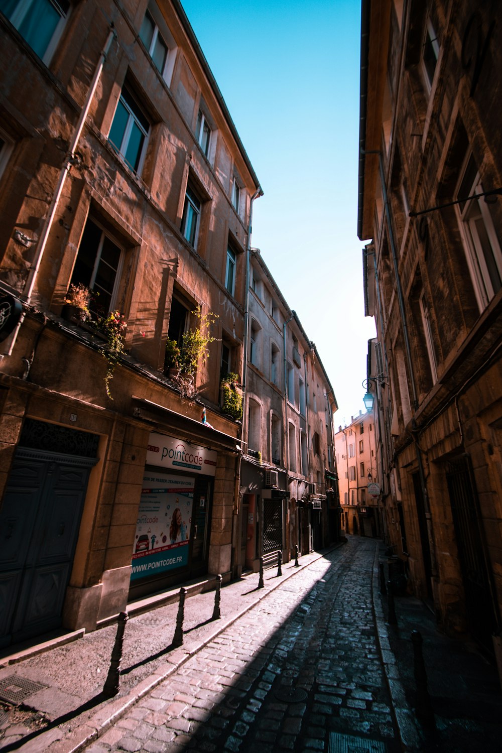 a cobblestone street between buildings