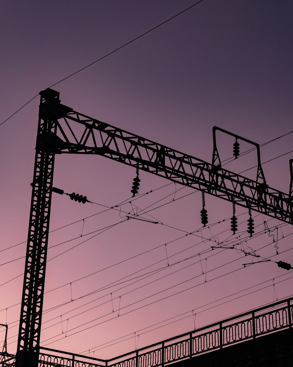 a roller coaster with a pink sky