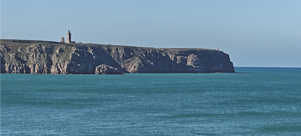 a rocky island with a lighthouse