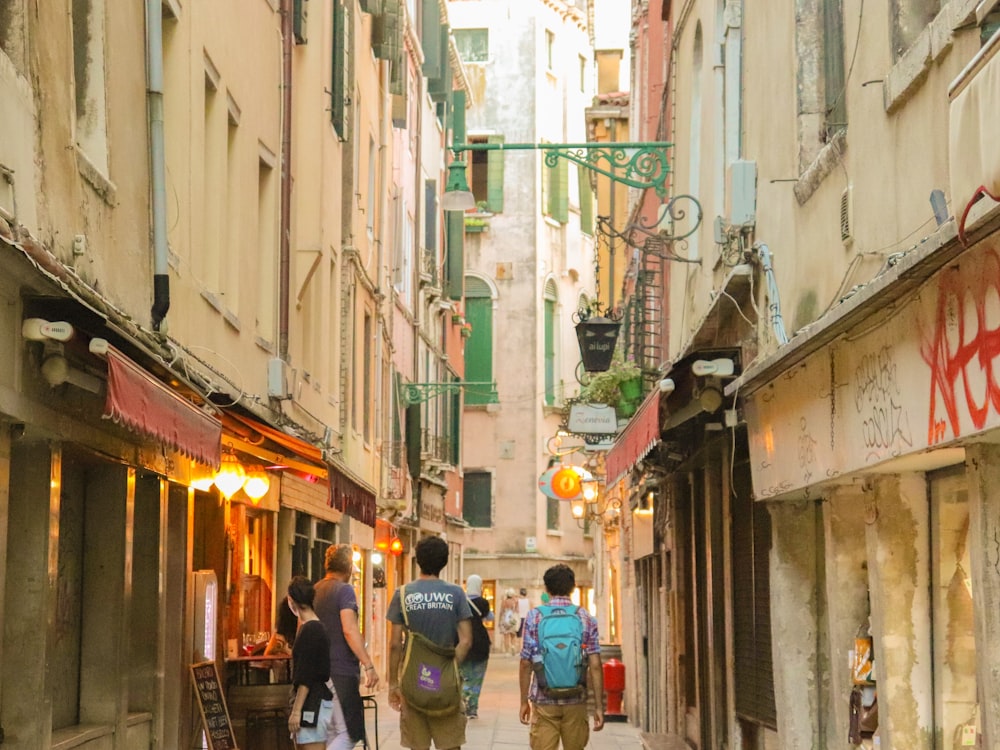 people walking in a narrow alley