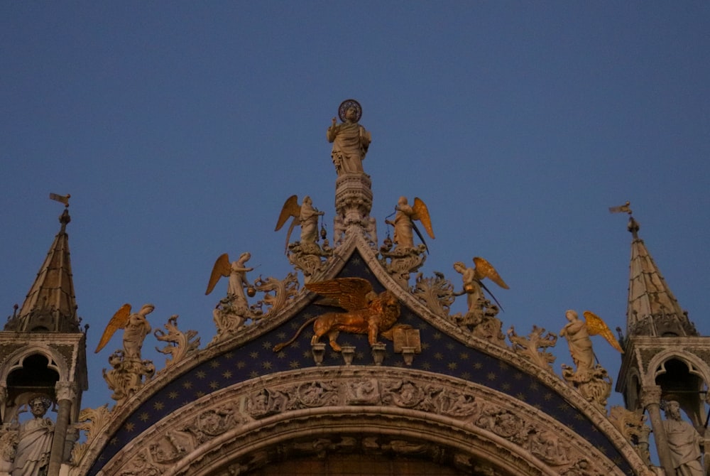 a building with statues on the roof