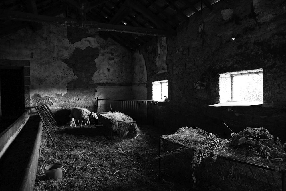 a room with a few bales of hay and a window