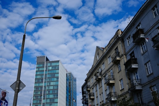A vibrant street scene in Hamburg-Harburg showing a mix of modern buildings and historic architecture under a bright sky.