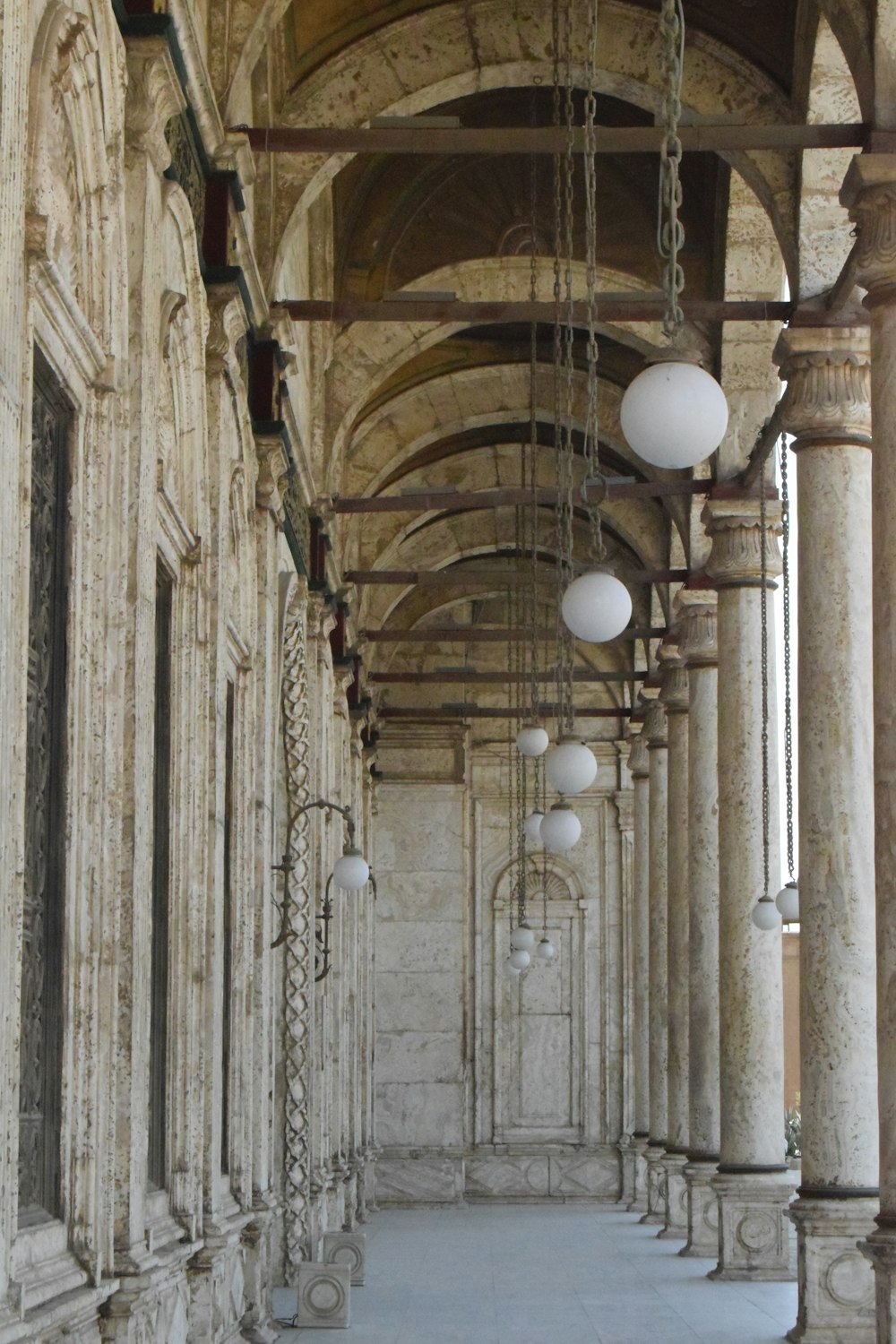 a hallway with white lamps