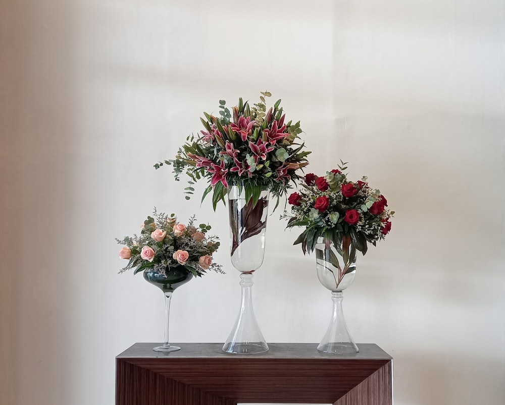 a couple of vases with flowers