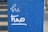 White handwritten text on a textured blue surface reads 'hi thao'. The background shows blurred steps or stripes in similar blue tones.