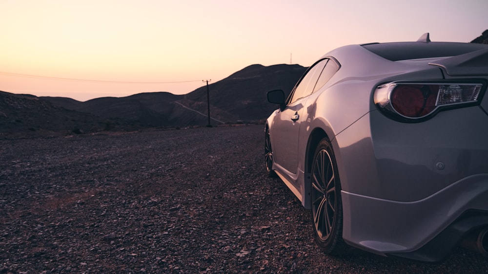 a car parked on a gravel road