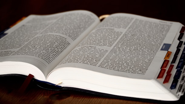 an open book with a pen