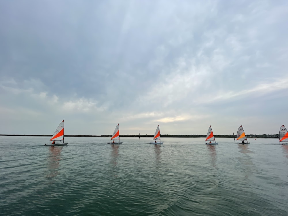 a group of people rowing a boat in the water