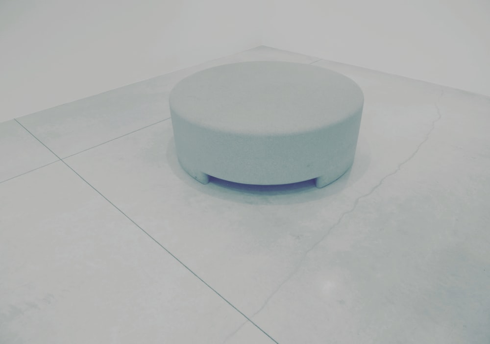 a white circular object on a tile floor