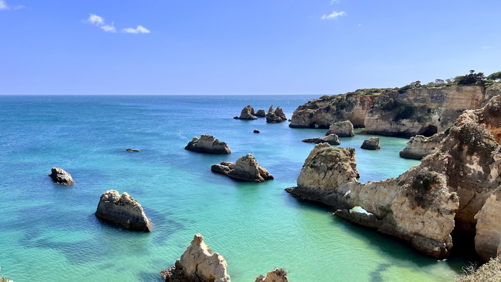 a rocky beach with blue water