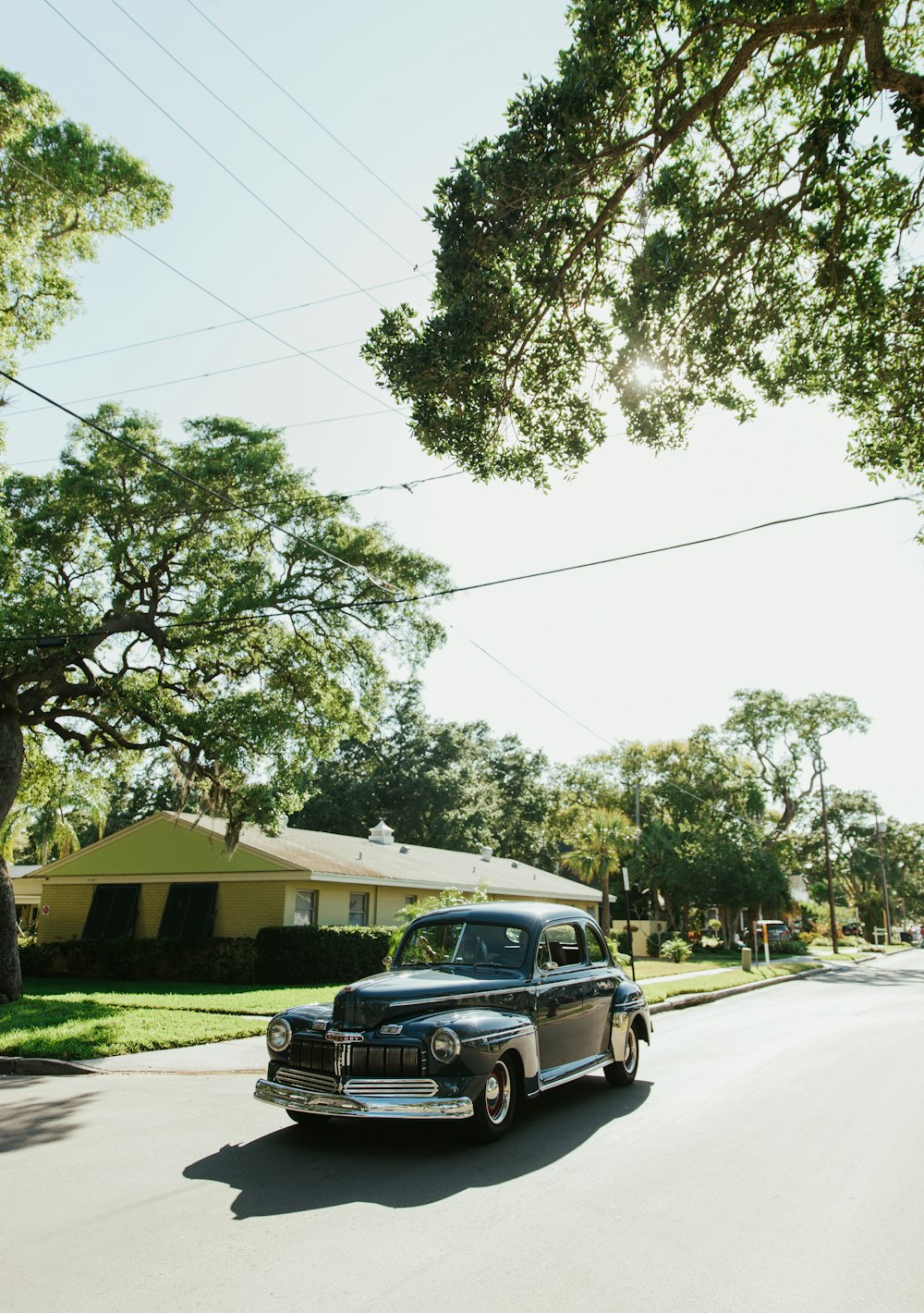 an old car parked on the side of a road