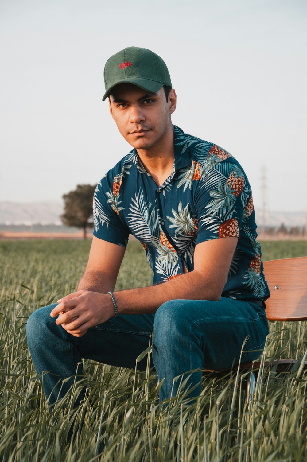 a man sitting in a grassy area