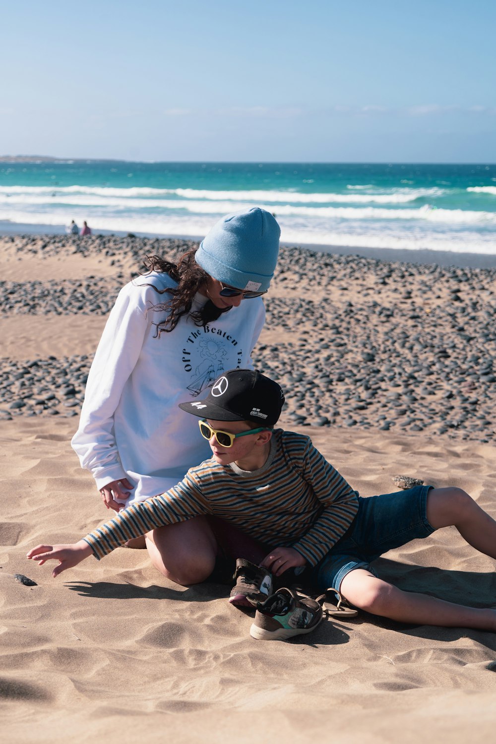 a person and a boy on a beach