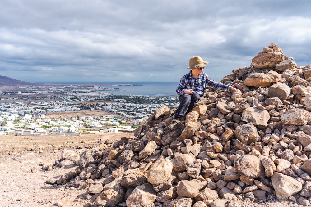 a man sitting on a rock