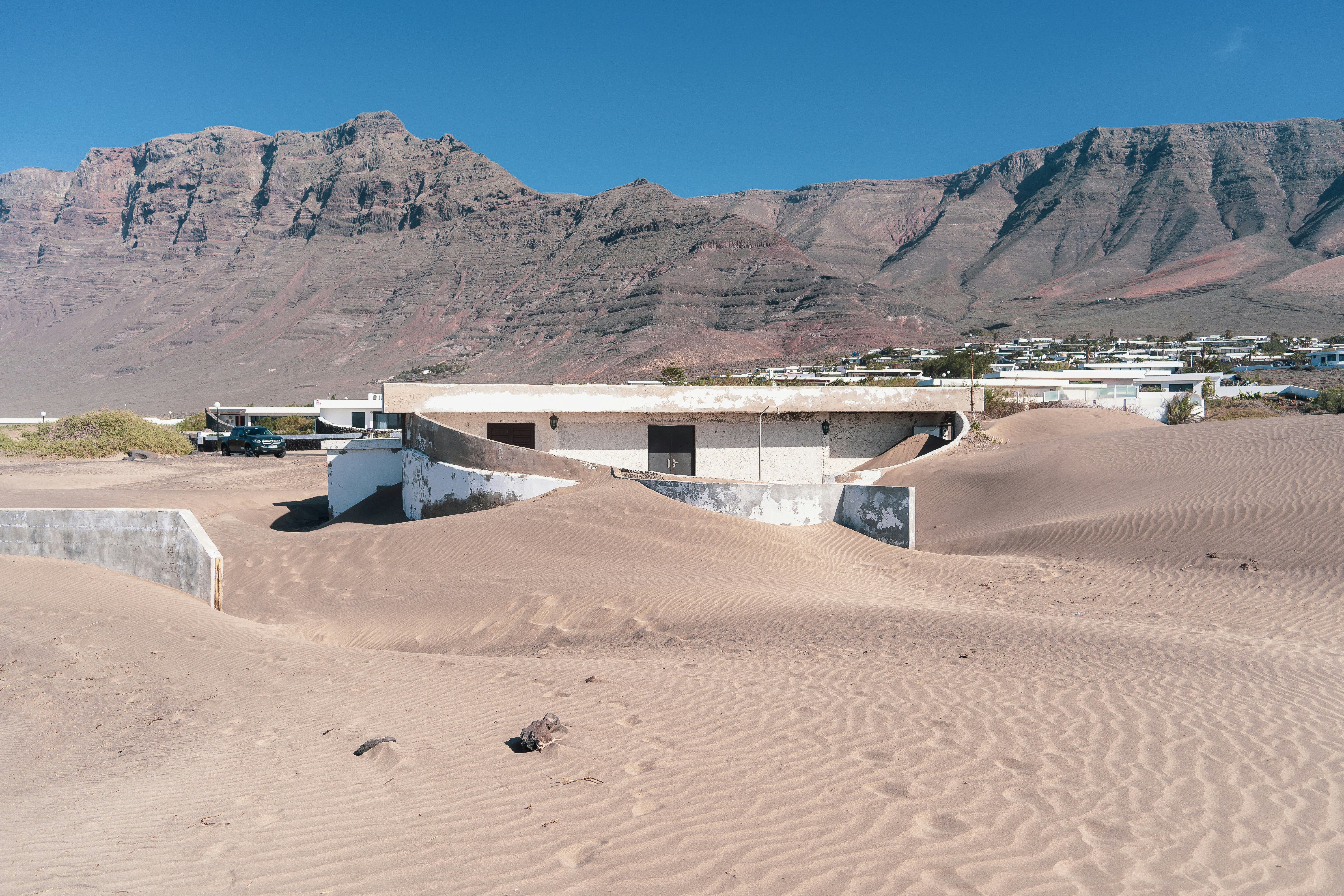 a building in a desert, House swallowed by sand storm