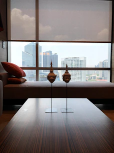 Modern apartment with red sandalwood paneling and large windows overlooking the city skyline.