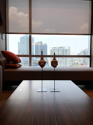 Modern apartment with red sandalwood paneling and large windows overlooking the city skyline.