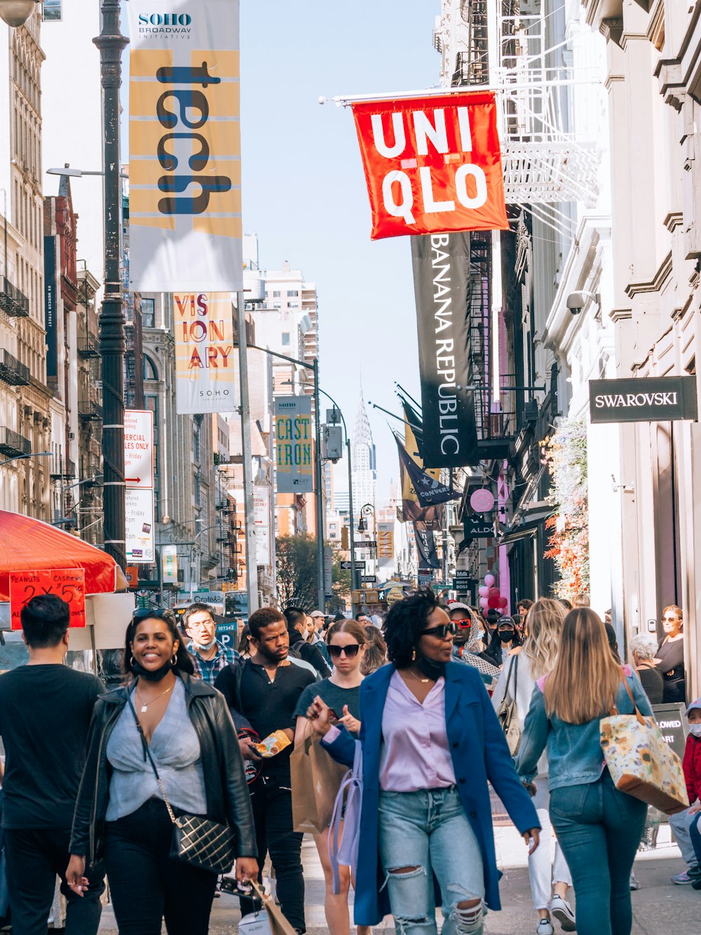 a group of people walking down a busy street