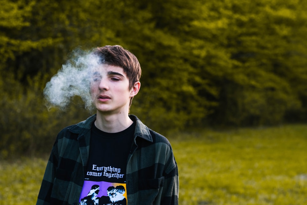 a man with a white cloud of smoke behind him