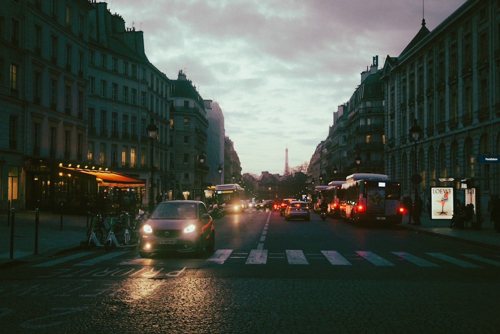 a city street with cars and buses