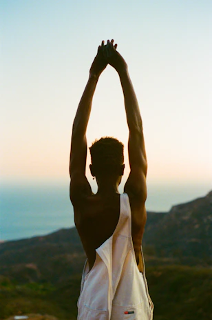 A person stretching outdoors at sunrise, embodying recovery and strength.
