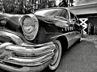A beautifully restored vintage car parked outdoors.